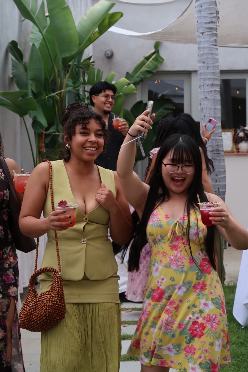Two creators laughing with drinks at the AHA event