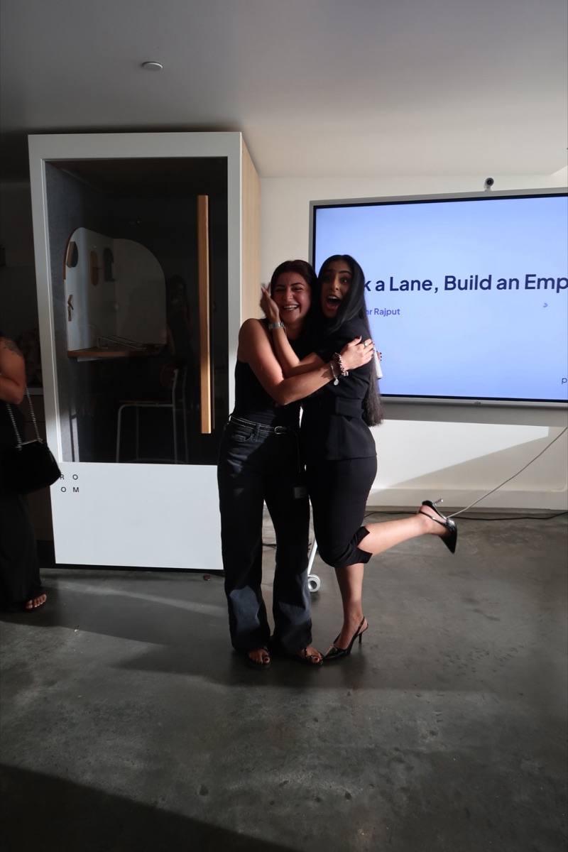 Mehr jumping into a hug in front of her Pick a Lane, Build an Empire talk