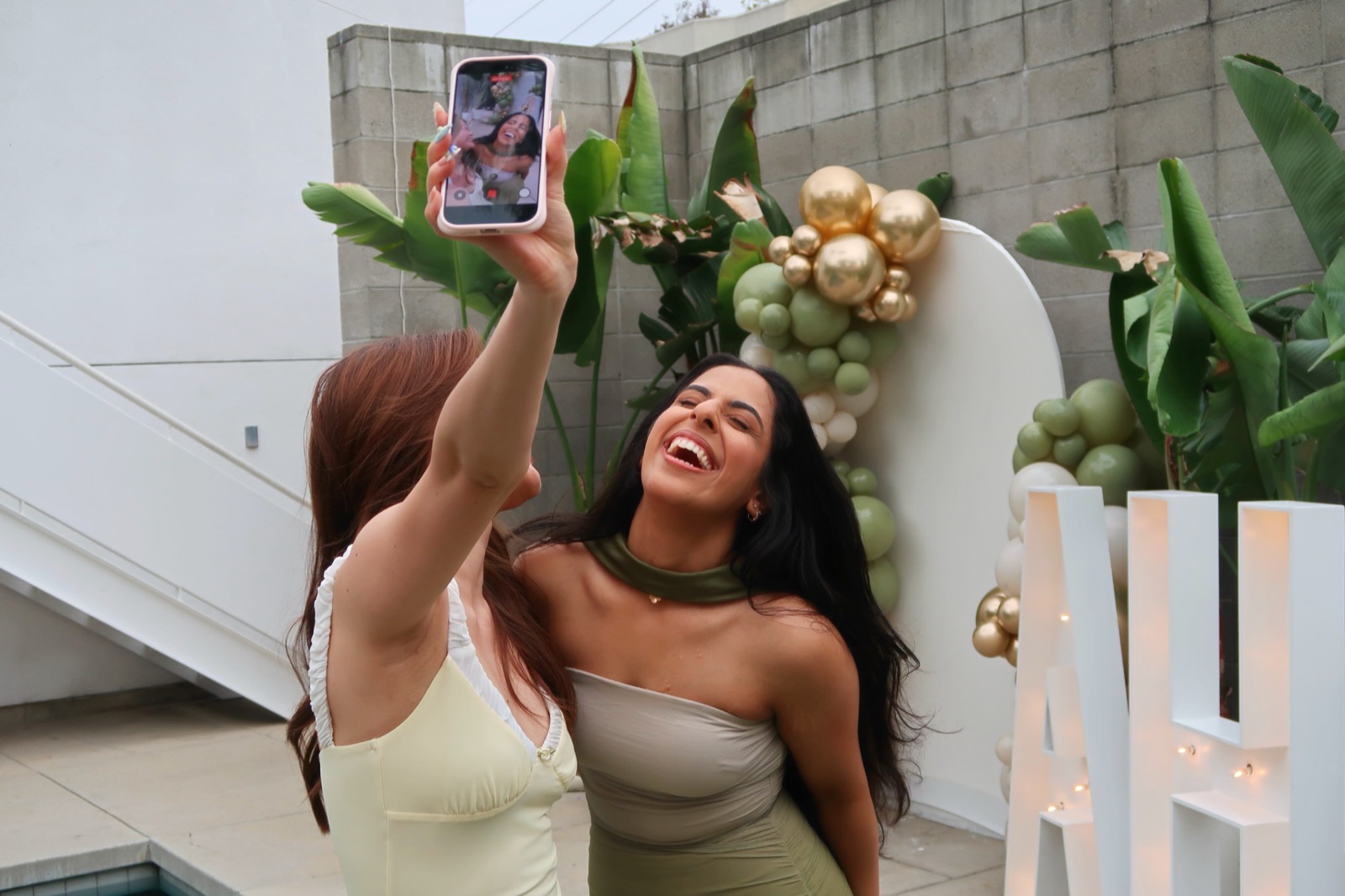 Mehr laughing with a creator taking a selfie